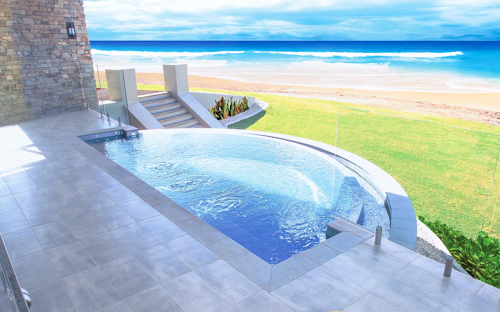 Leisure Pools Horizon fiberglass in-ground swimming pool with an infinity edge