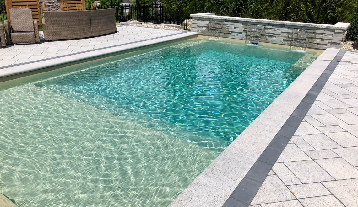 Leisure Pools Pinnacle swimming pool in Diamond Sand Leisure Pools Pinnacle large precast swimming pool with built-in splash deck
