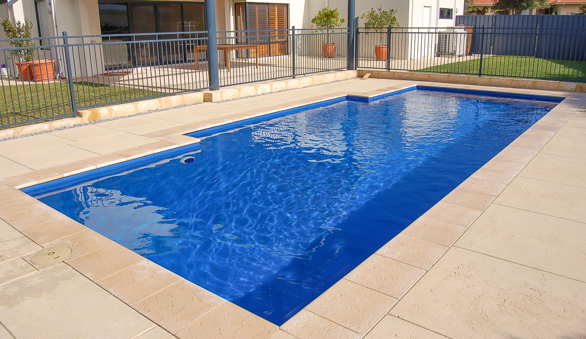 Leisure Pools Elegance fiberglass swimming pool with perimeter safety ledge