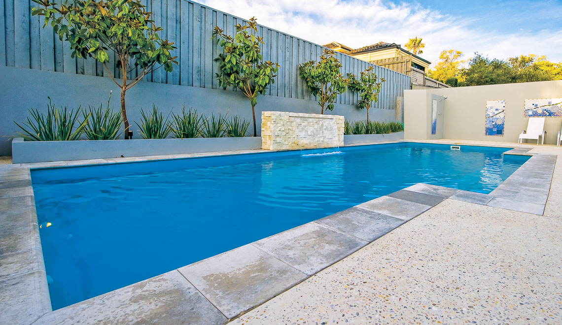 Leisure Pools Elegance inground fiberglass swimming pool with built-in steps