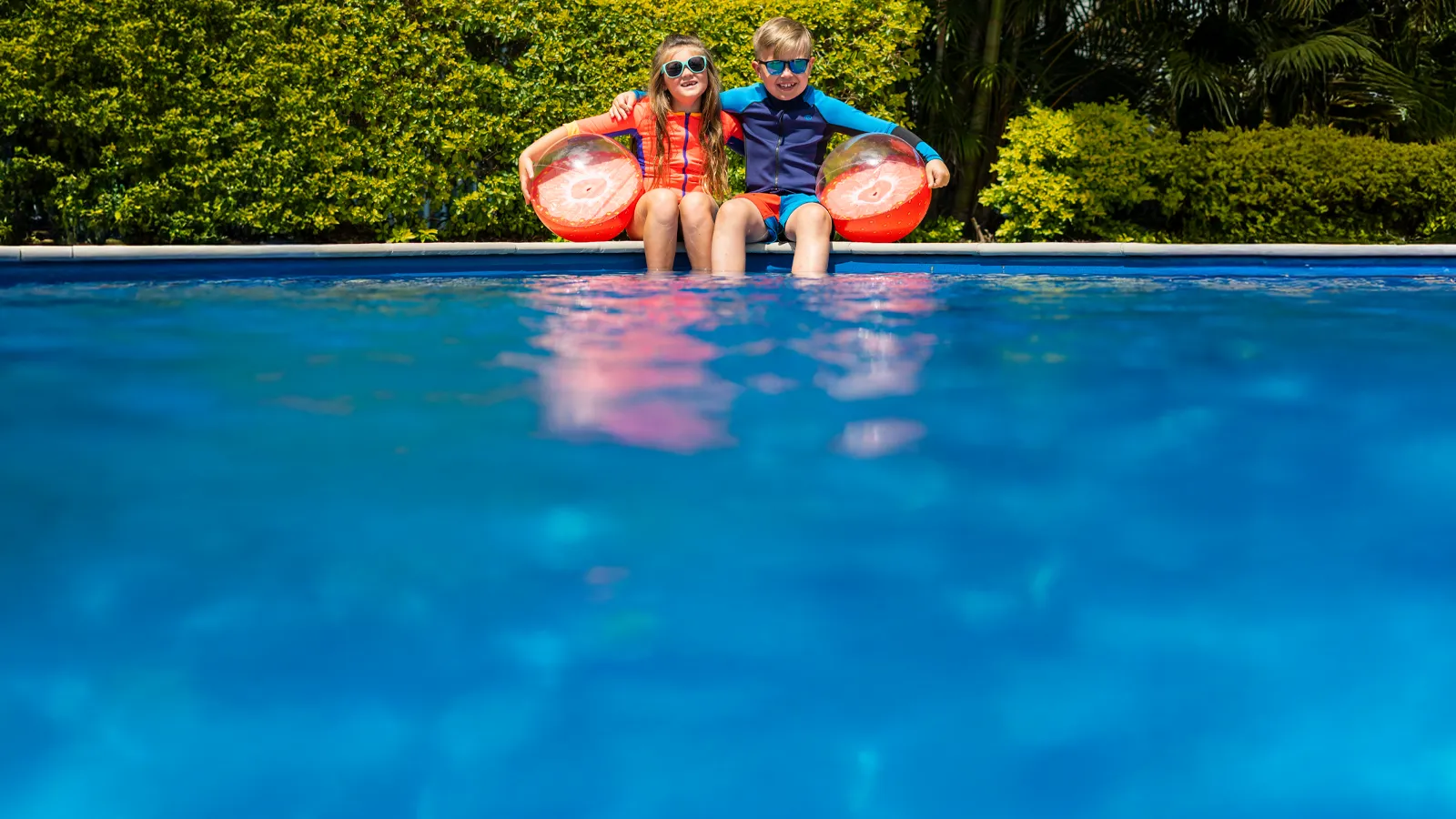 IMG LP AU Kids Sitting By Pool 25 years of Leisure Pools