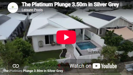 The Platinum Plunge 3.50m fibreglass swimming pool is installed in a modern house with white tiles and pool accessories surrounding it. The beautiful Silver Grey pool colour matches perfectly with the grey dusk sky.